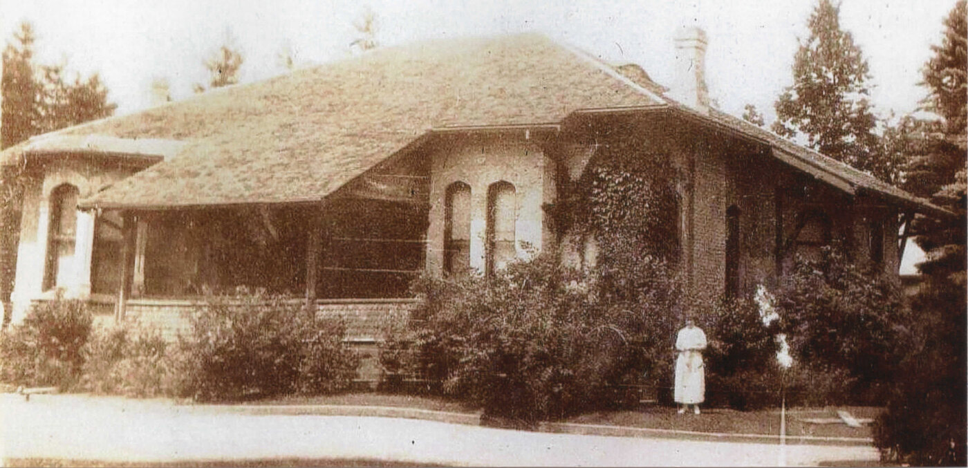 The Gore after its 1922 reduction to a single-storey bungalow, a woman standing in front