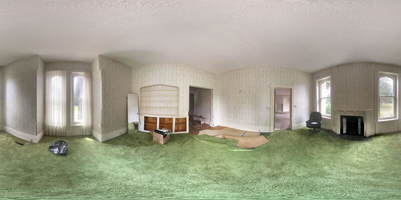 360° view of a drawing room with built-in shelving and tall windows